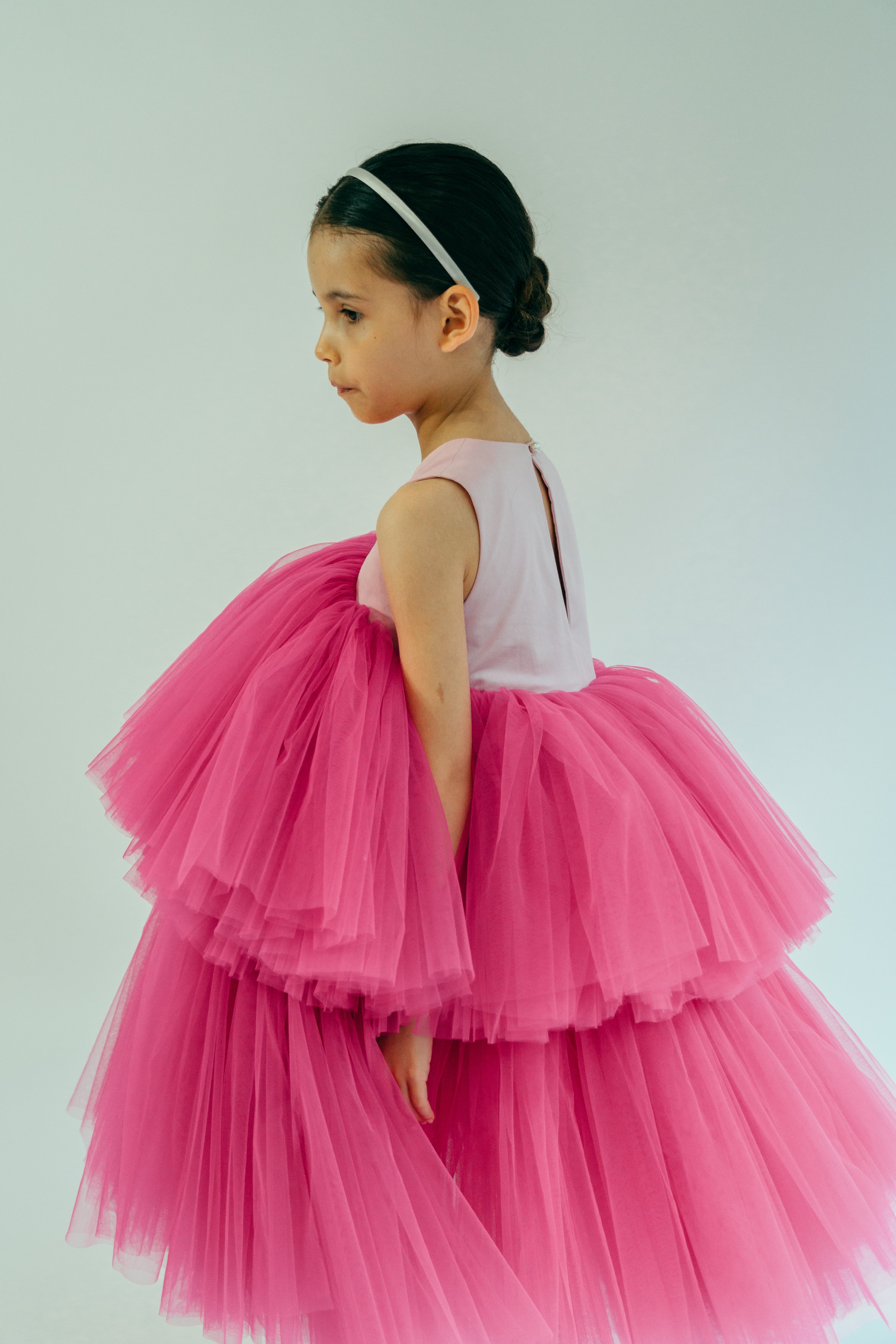Child wearing a pink puffy tulle dress
