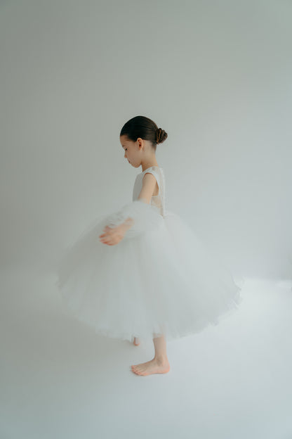 Girl in white tulle juju dress looking like a princess