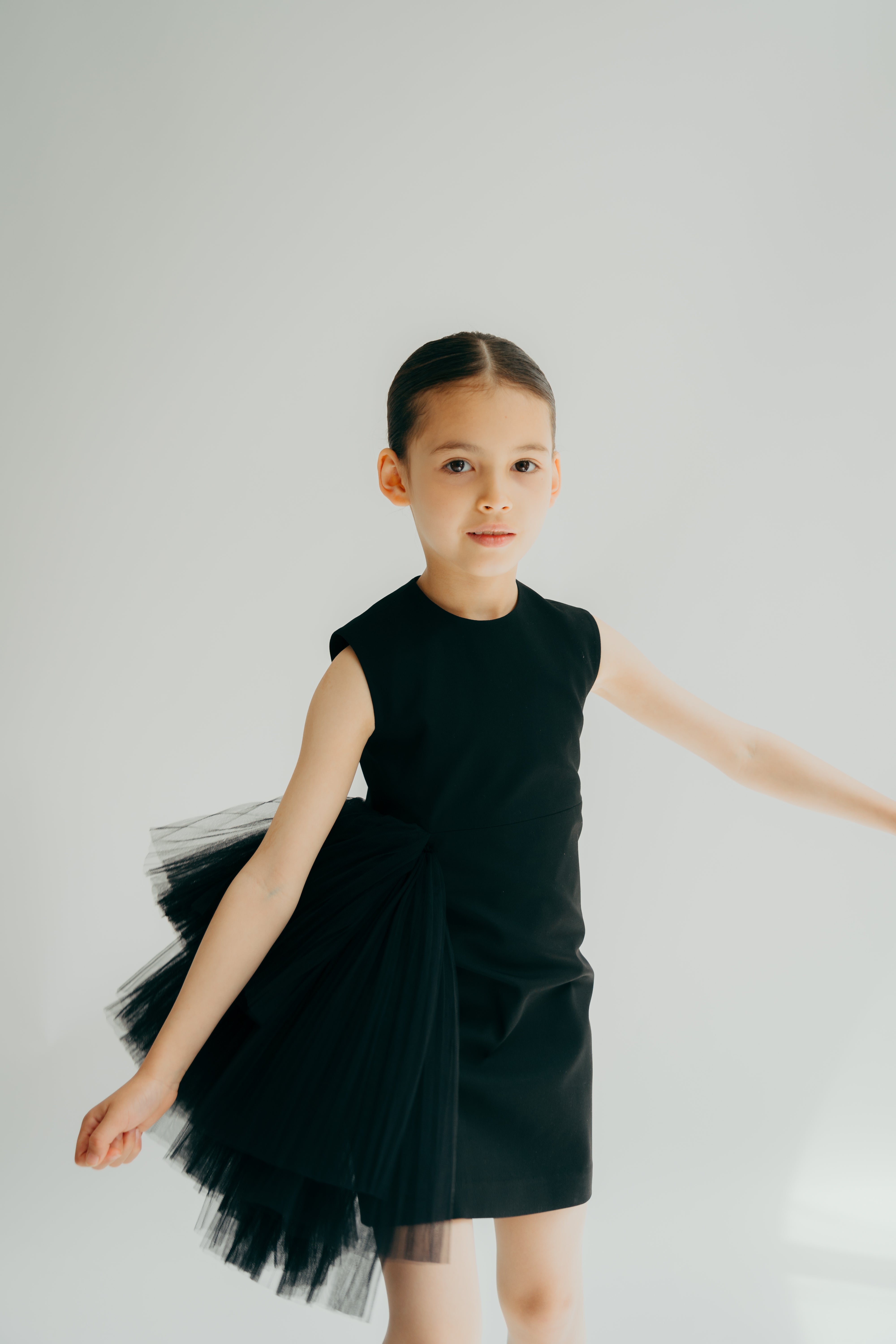 Girl moving in a black sleeveless straight dress