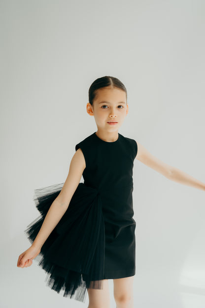 Girl moving in a black sleeveless straight dress