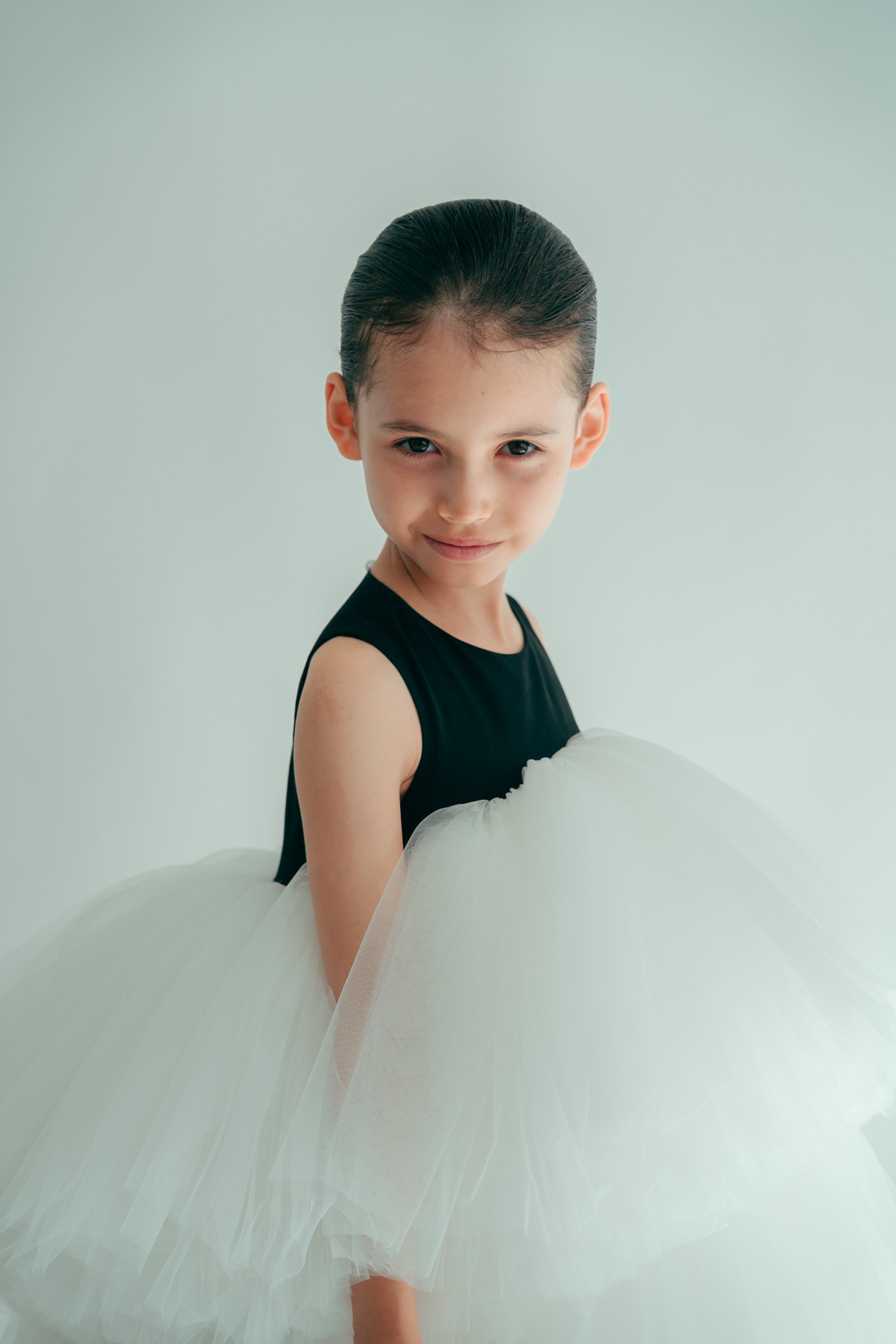 Girl from profile wearing a black and white dress with puffy tulle layers